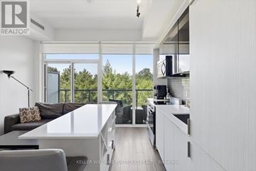 Toronto (Casa Loma) condo for rent - A modern kitchen with a dining table and chairs.