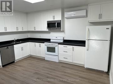 Toronto (Banbury-Don Mills) apartment for rent - A kitchen with white cabinets and a white fridge.