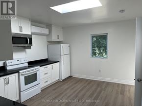 Toronto (Banbury-Don Mills) apartment for rent - A kitchen with white appliances and cabinets.