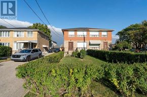 Toronto (Brookhaven-Amesbury) apartment for rent - A residential area with houses and a car parked in the driveway.