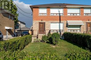 Toronto (Brookhaven-Amesbury) apartment for rent - A red brick house with a brown door and a small tree in the front yard.