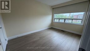 Toronto (Brookhaven-Amesbury) apartment for rent - A room with a window showing a view of a building outside.