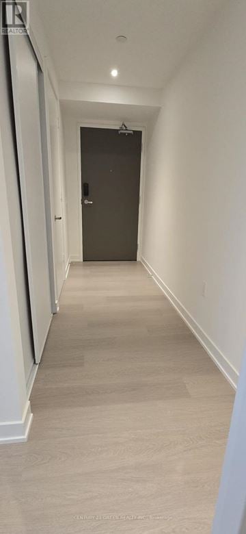 Mississauga (City Centre) condo for rent - A long hallway with a door at the end.