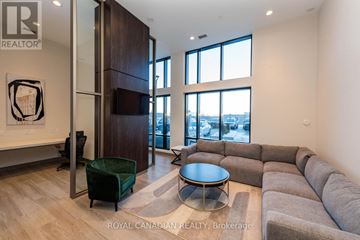 Milton (Co Coates) condo for rent - A living room with a grey sofa and a glass table.