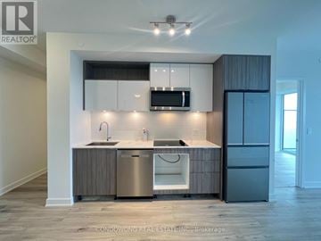 Toronto (Waterfront Communities) condo for rent - A modern kitchen with a sink, stove, and refrigerator.