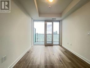 Toronto (Waterfront Communities) condo for rent - A room with a sliding glass door leading to a balcony.