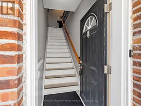 Vaughan (Kleinburg) apartment for rent - A set of stairs leading to a black door with a white arch above the door.