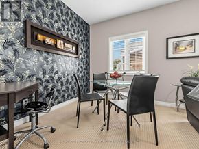 Vaughan (Kleinburg) apartment for rent - A room with a wallpapered wall and a glass table with chairs.
