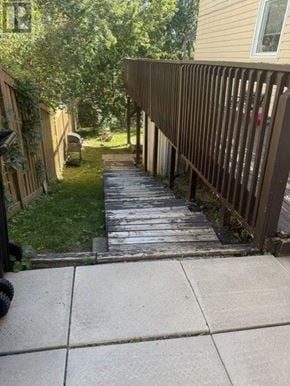Barrie (Letitia Heights) apartment for rent - A wooden fence runs along the side of a concrete walkway.