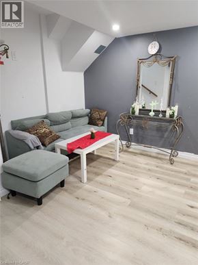 Kitchener apartment for rent - A dining area with a table set for two and a television mounted on the wall.