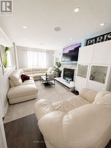 Brampton (Heart Lake West) apartment for rent - A living room with white furniture and a flat screen TV.