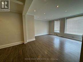 Shelburne multi-family for rent - A room with wooden flooring and a window with blinds.