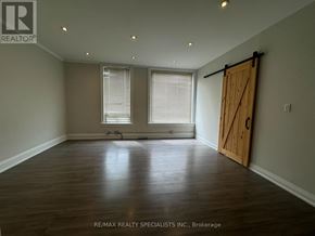 Shelburne multi-family for rent - A room with a wooden floor and a sliding door.