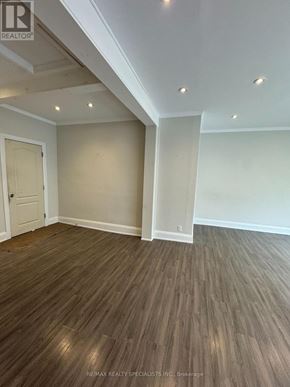 Shelburne multi-family for rent - A room with wooden flooring and a door on the left side.