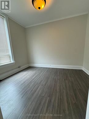Shelburne multi-family for rent - A room with a wooden floor and a window with blinds.