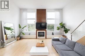 Toronto (Kensington-Chinatown) townhouse for rent - A living room with a grey sofa and a wooden coffee table.