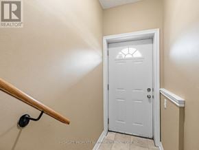 Vaughan (Kleinburg) apartment for rent - A white door with a window in the middle is in a room with beige walls.