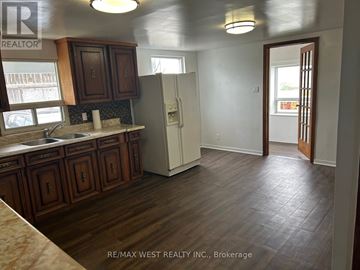 Brampton (Vales Of Castlemore) apartment for rent - A kitchen with wooden cabinets and a white refrigerator.