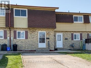 Woodstock (Woodstock - North) townhouse for rent - A two-story house with a brown roof and beige siding.