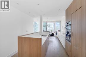 Vancouver apartment for rent - A modern kitchen with wooden cabinets and a large island.