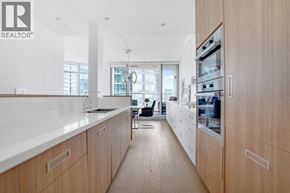 Vancouver apartment for rent - A modern kitchen with wooden cabinets and a white countertop.