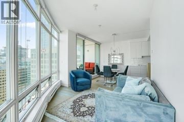Vancouver apartment for rent - A living room with a blue couch and a rug with a heart design on it.