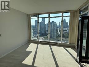 Burnaby apartment for rent - A room with a large window overlooking a cityscape.