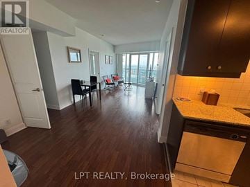 Mississauga (City Centre) condo for rent - A kitchen with a dining table and chairs in a room with wooden flooring.
