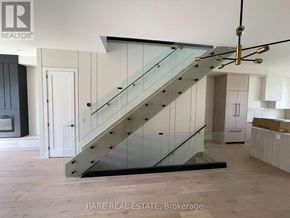 Toronto (Long Branch) apartment for rent - A staircase with a glass railing and wooden steps.