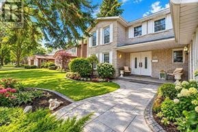 Mississauga (Sheridan) apartment for rent - A house with a front yard and a driveway.