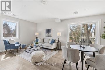 Stratford condo for rent - A well-lit living room with a dining table set up.