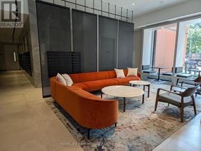 Toronto (North St. James Town) condo for rent - A living room with a sofa, chairs, and a coffee table.