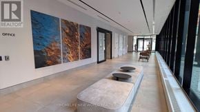Toronto (North St. James Town) condo for rent - A long hallway with a rug and a wall with a painting on it.