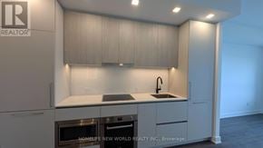 Toronto (North St. James Town) condo for rent - A modern kitchen with a stainless steel oven and a sink with a faucet.