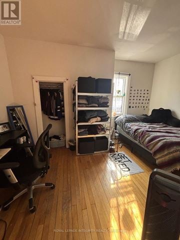 Ottawa townhouse for rent - A bedroom with a bed, chair, and a window.
