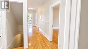 Ottawa townhouse for rent - A hallway with white walls and wooden floors.