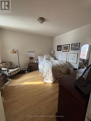 Ottawa townhouse for rent - A room with a bed, a couch, and a desk.