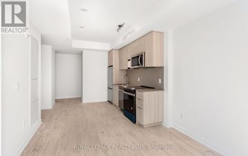 Milton (Cb Cobban) condo for rent - A kitchen with a microwave above the stove and a counter.