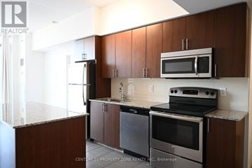 Toronto (Yorkdale-Glen Park) condo for rent - A kitchen with a stove top oven and microwave above it.