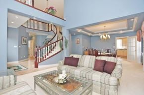 Surrey apartment for rent - A living room with a couch, coffee table, and staircase.