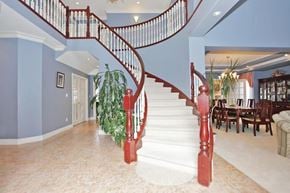 Surrey apartment for rent - A staircase with red balusters and white steps.