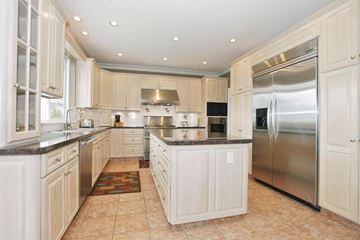 Surrey apartment for rent - A kitchen with white cabinets and a refrigerator.