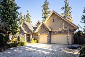 Surrey apartment for rent - A house with a stone facade and a garage door.