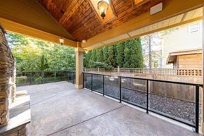 Surrey apartment for rent - A patio with a black railing and a wooden ceiling.