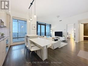Toronto (Bay Street Corridor) condo for rent - A modern dining room with a white table and chairs.