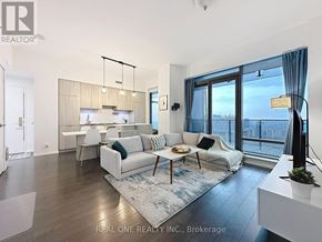Toronto (Bay Street Corridor) condo for rent - A modern living room with a view of the city.