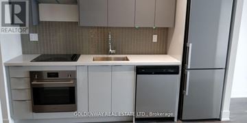 Vaughan (Concord) condo for rent - A kitchen with a sink, stove and refrigerator.