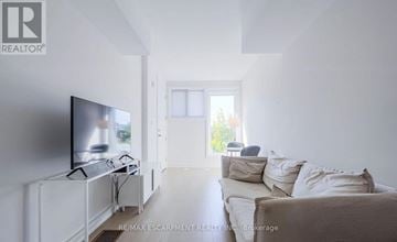 Toronto (Rustic) townhouse for rent - A living room with a television and a couch.