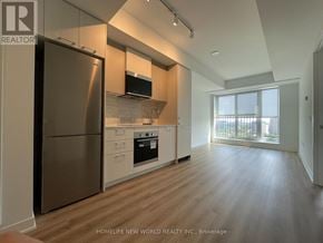 Toronto (Regent Park) condo for rent - A modern kitchen with stainless steel appliances and wooden flooring.