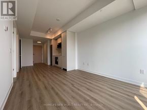Toronto (Regent Park) condo for rent - A spacious room with wooden flooring and white walls, likely for sale.